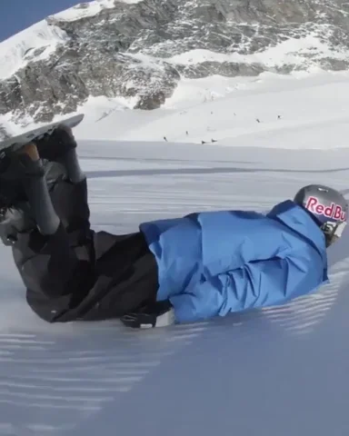 Snowboarder aliding on his stomach
